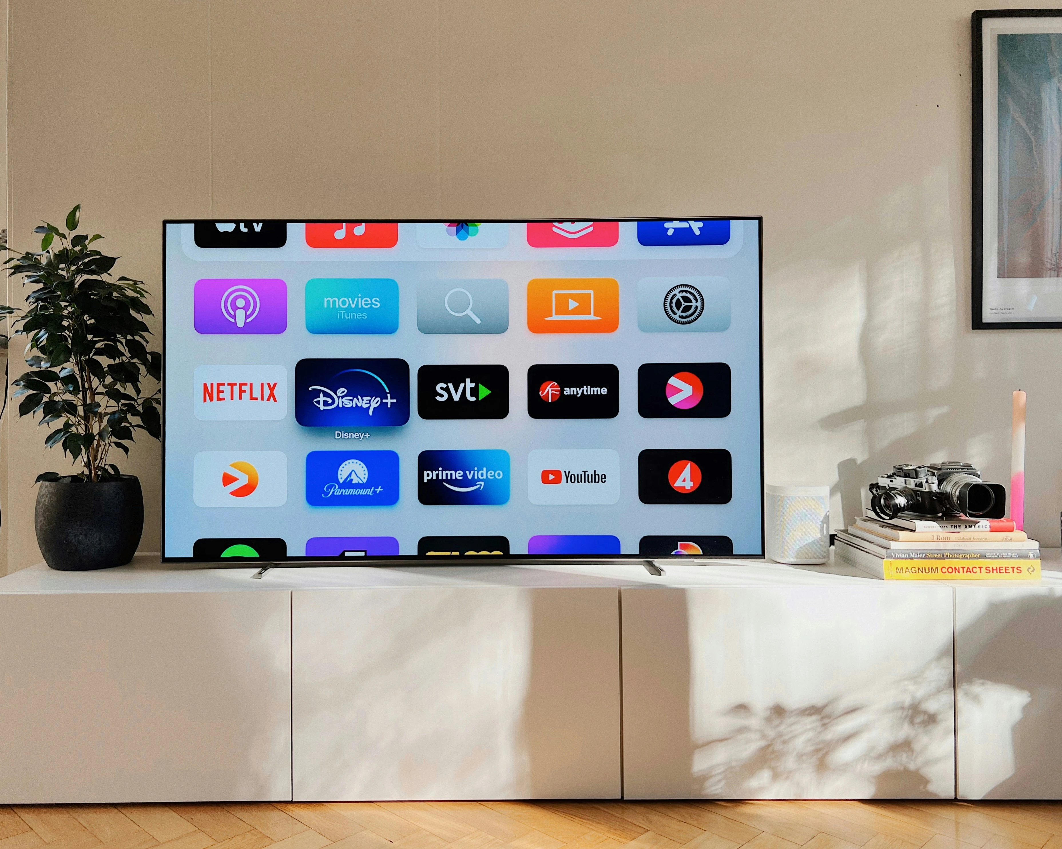 Photo of a flat screen TV sitting on top of a white cabinet